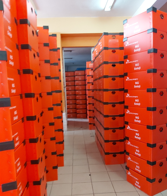Gray industrial tote with bright blue corrugated plastic divider inserts and small metal parts.